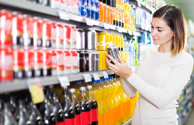 woman choosing a drink in the supermarket