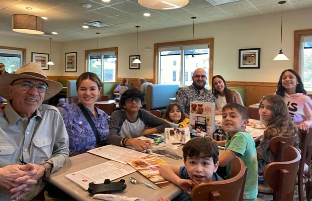photograph of a family sharing in a restaurant