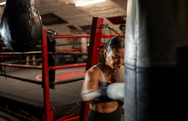 Photograph of a woman exercising with a punching bag