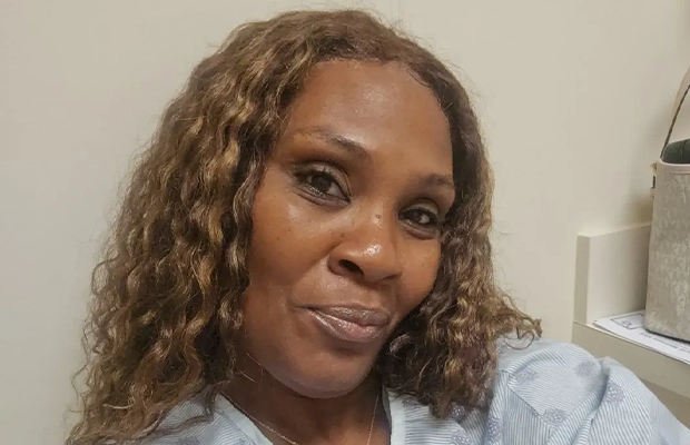 Selfie of a woman with curly blonde hair.