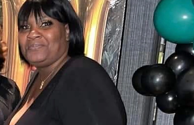 Close-up of a woman with short black hair dressed in black