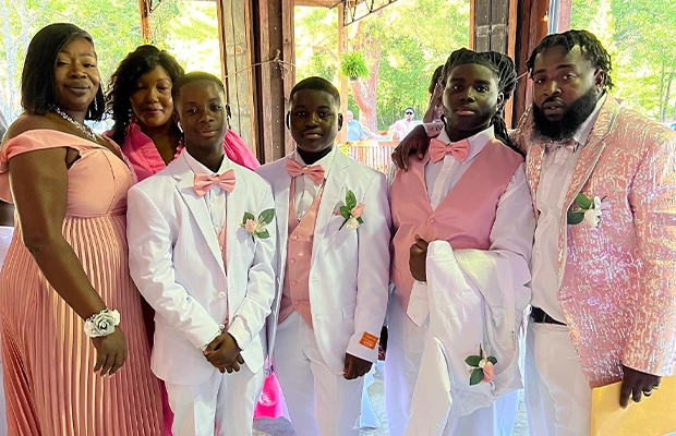family photograph of people dressed in suits during marriage