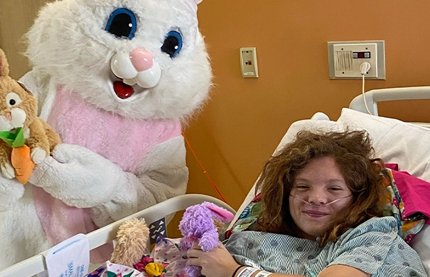 A person in a hospital bed with a person in a garment