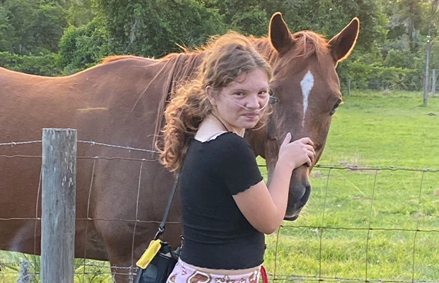 A child petting a horse