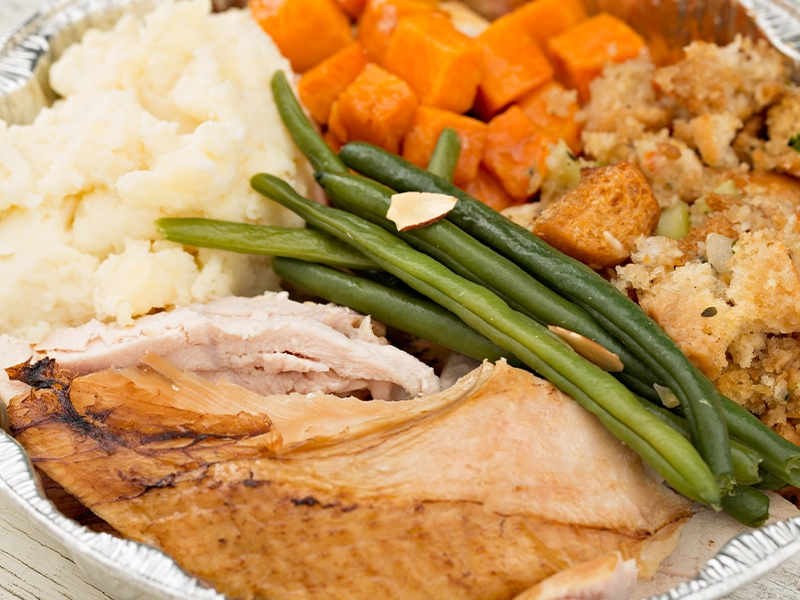 a dish with turkey, beans, potato and carrot