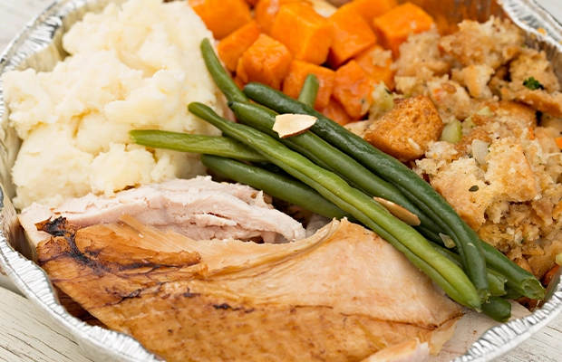 a dish with turkey, beans, potato and carrot