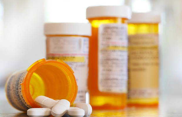 Photograph of an orange medicine bottle.