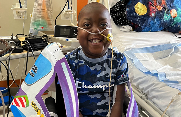 Boy sitting in hospital room with oxygen valve