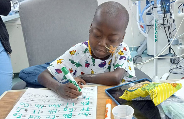 Child in hospital room drawing pictures