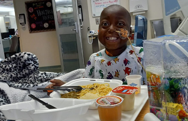 Boy smiling in hospital at lunch time