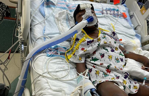 Intubated boy lying on hospital gurney