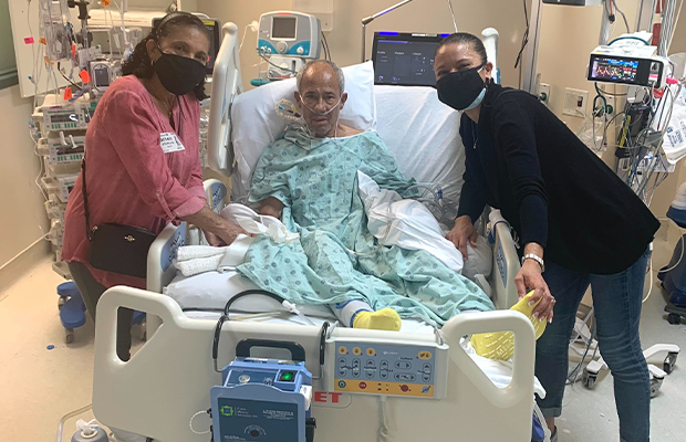 hospitalized man smiling with his family