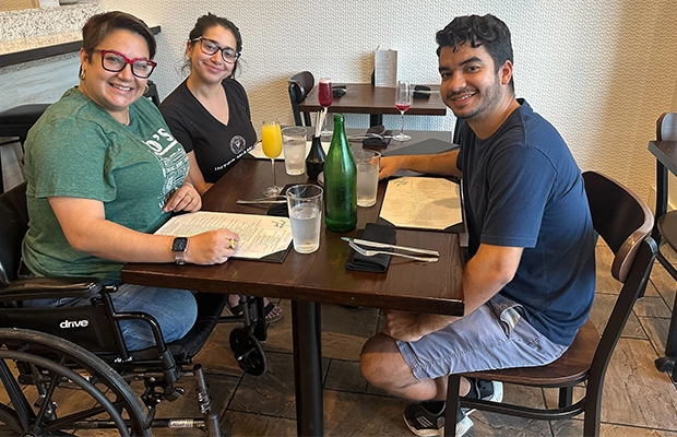 woman in wheelchair accompanied by family