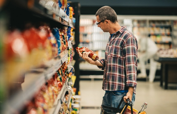 man checking products in supermarket