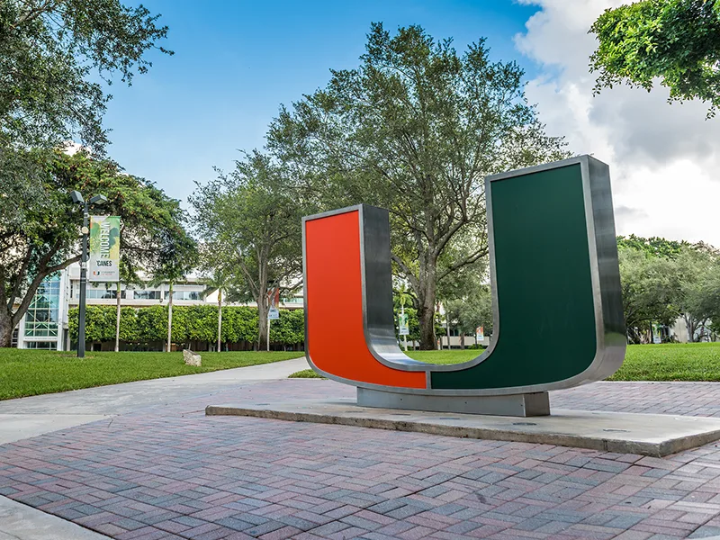 An outdoor environment, there's a large U statue