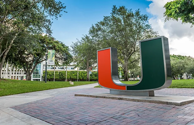 An outdoor environment, there's a large U statue