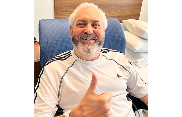 man giving a thumbs up and smiling at the camera