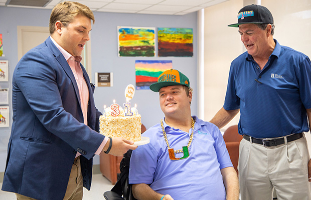 James “Woody” Beckham with his family about to flow the candles on his 31st birthday cake