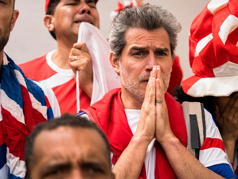worried man watching a match at the stadium