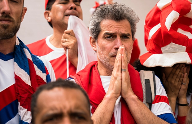 worried man watching a match at the stadium