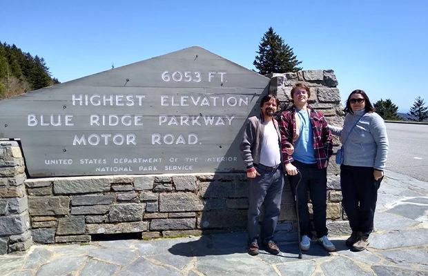 three friends posing and smiling at the camera