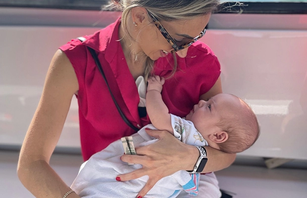 mother holding and smiling at her baby