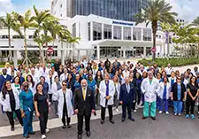 A large group of professionals standing in front of a medical building