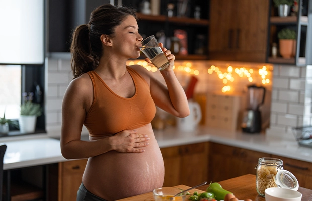 pregnant woman drinking water