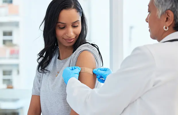Doctor giving a bandage to a patient