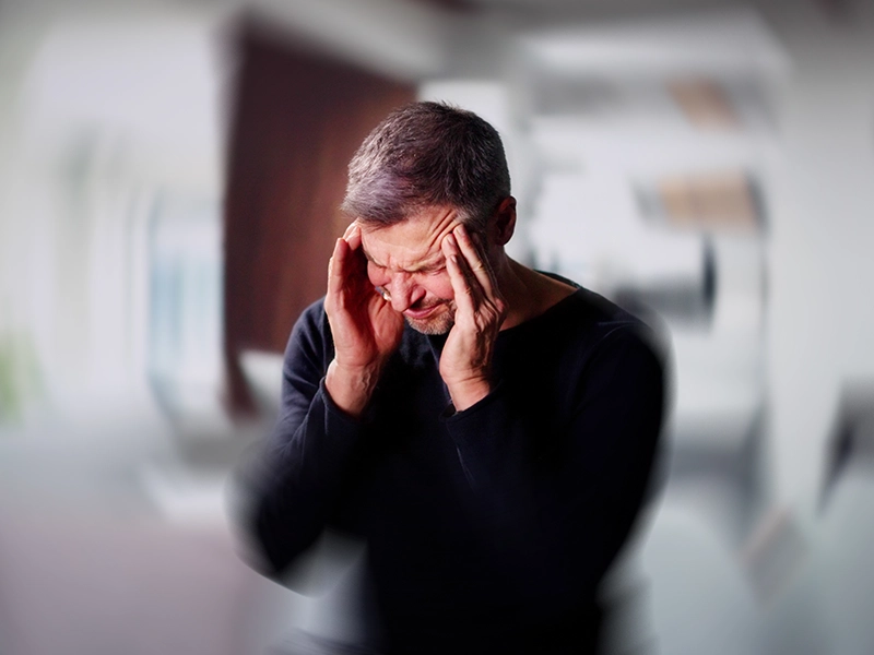 man suffering from severe headache