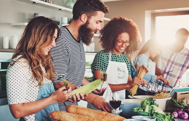 three people in the kitchen, preparing healthy food