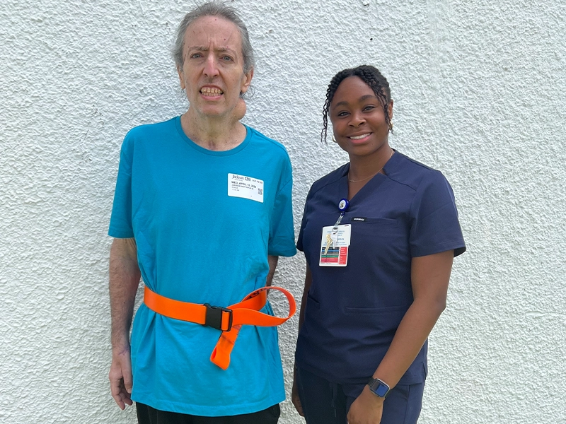 man with neck hernia next to nurse