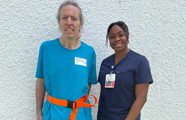 man with neck hernia next to nurse