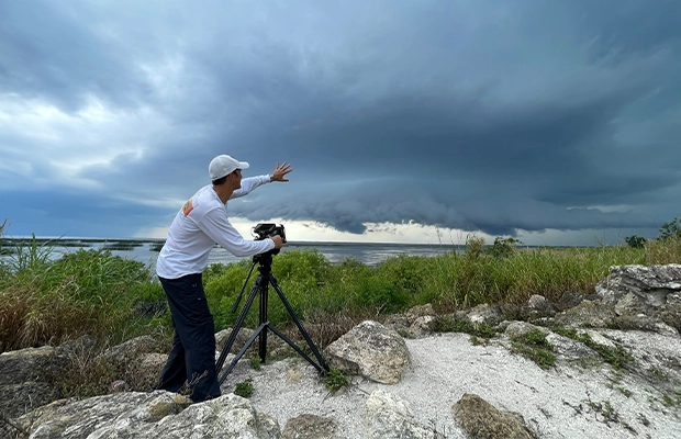 a man taking pictures on the beach