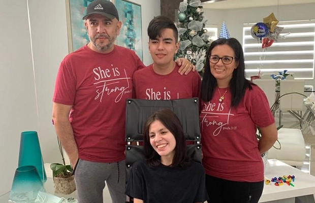 family posing and smiling at the camera