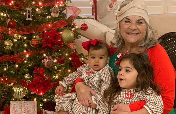 grandmother lifting her grandchildren