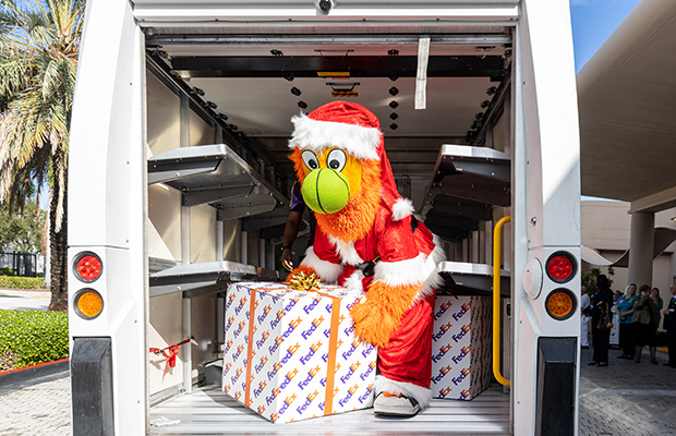 Miami HEAT mascot unloading gift from a delivery truck