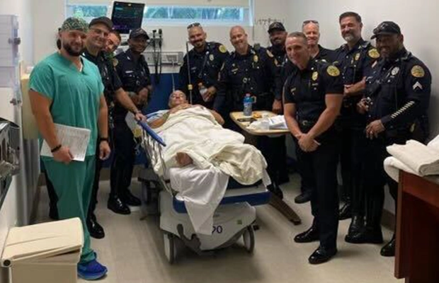 group of doctors and police officers next to a man on a stretcher