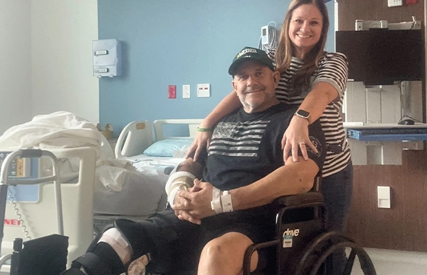 man in wheelchair posing next to woman