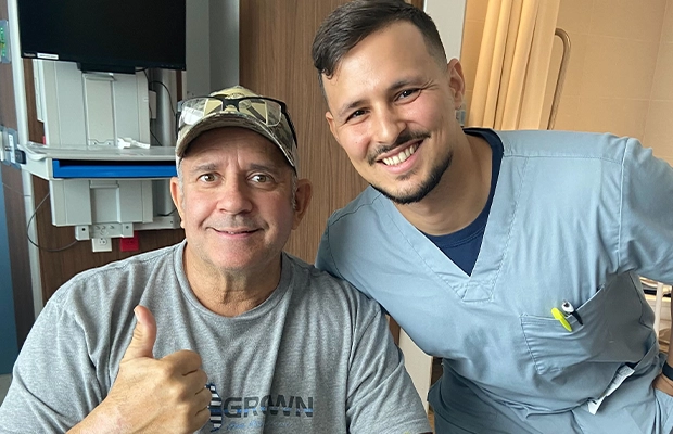two men posing and smiling at the camera
