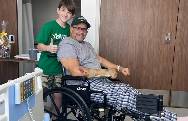 boy and man in wheelchair smiling at camera