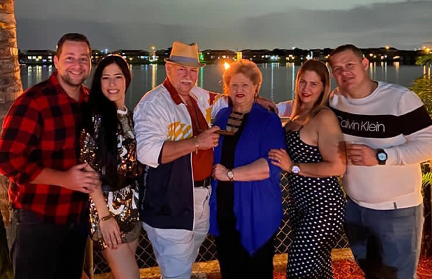 Group of people smiling and posing to the camera during celebration