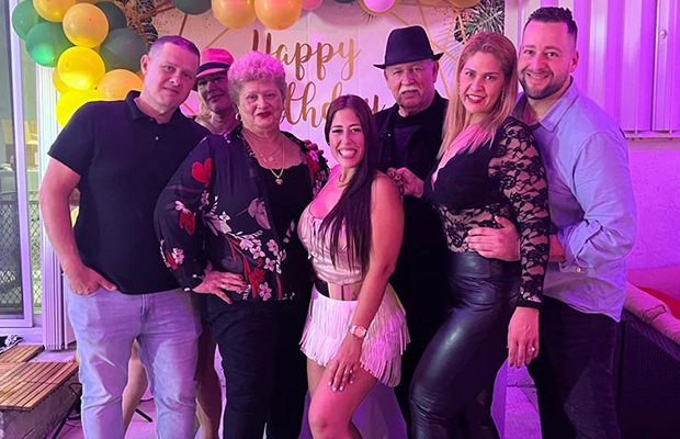 Group of people smiling and posing to the camera during celebration