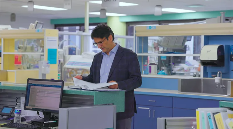 A professional looking at paperwork within a medical facility