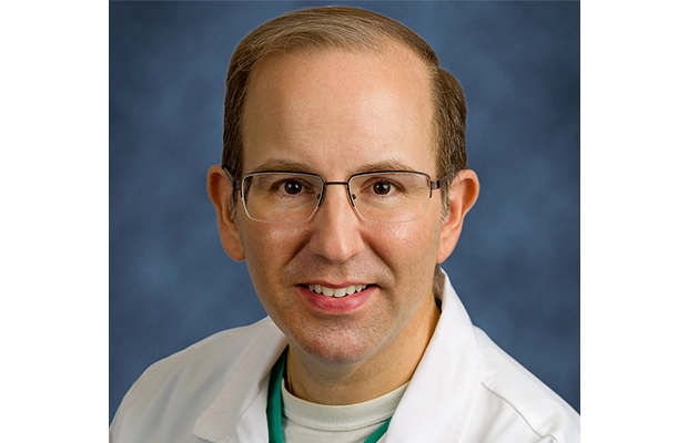 Close-up of a man wearing a white coat