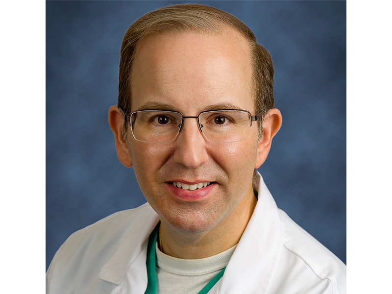 Close-up of a man wearing a white coat