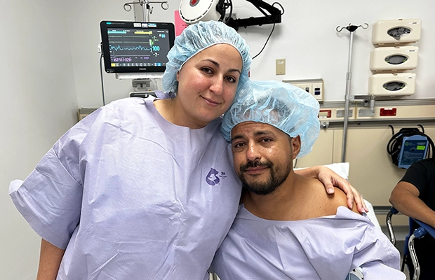 brothers hugging at the hospital while smiling to the camera