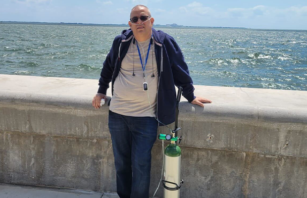 Man by the sea, with oxygen cylinder