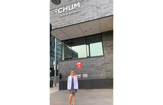woman posing next to a building