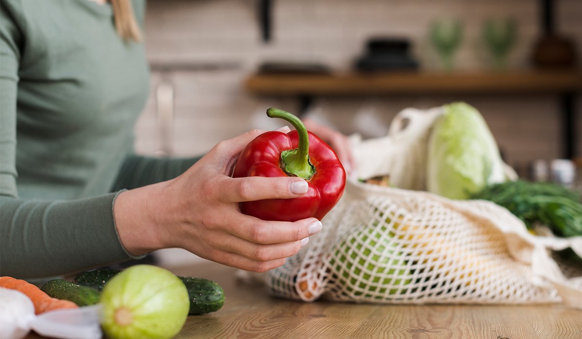 close-up-woman-holding-organic-vegetables